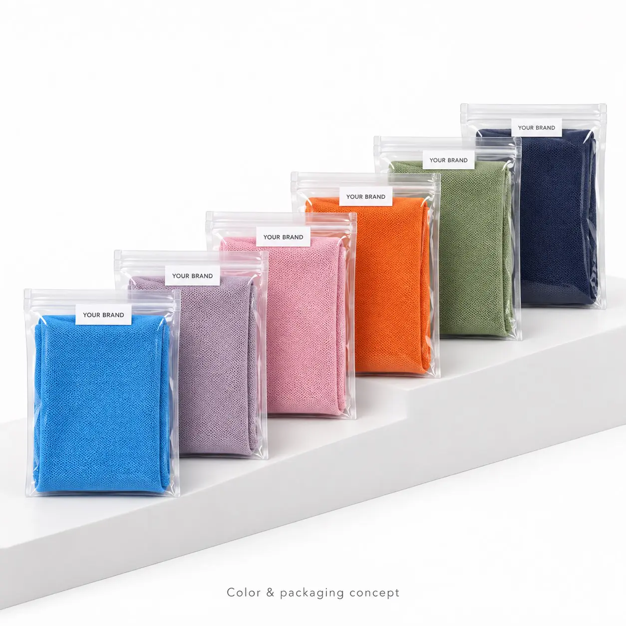 Six towel colors in transparent branded pouch concepts arranged on a stepped display