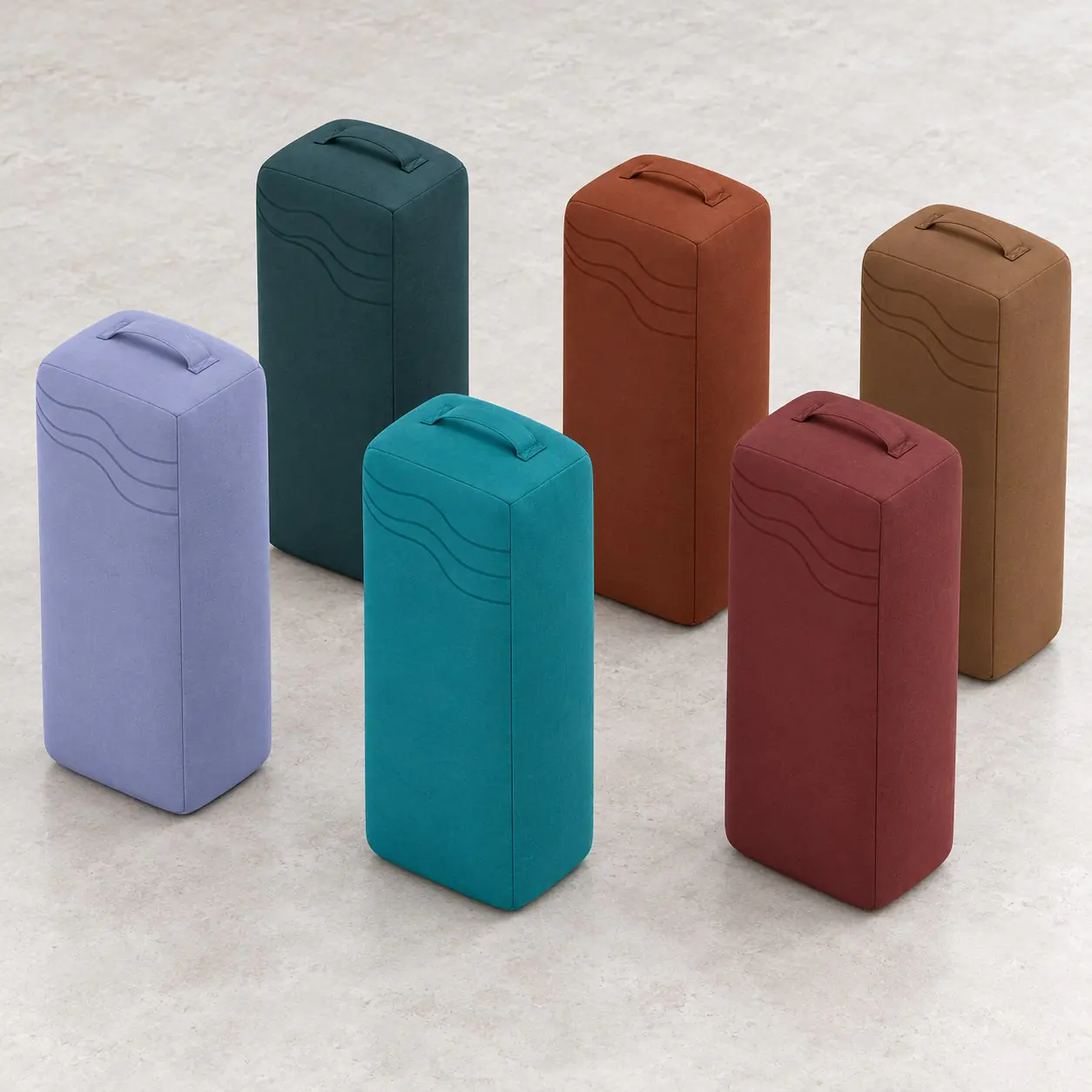 yj-602-03-color-collection.jpg Six rectangular yoga bolster color concepts arranged upright in a studio